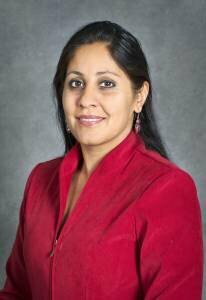 Image of a woman wearing a red top. Reshma Singh DOE