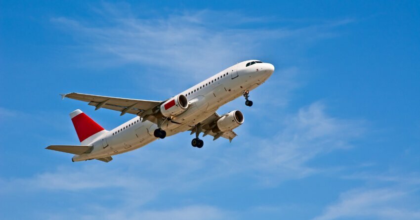 White airplane flying in a blue sky Sustainable Aviation Buyers Alliance