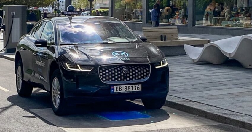 Black car using Wireless EV Charging in Europe