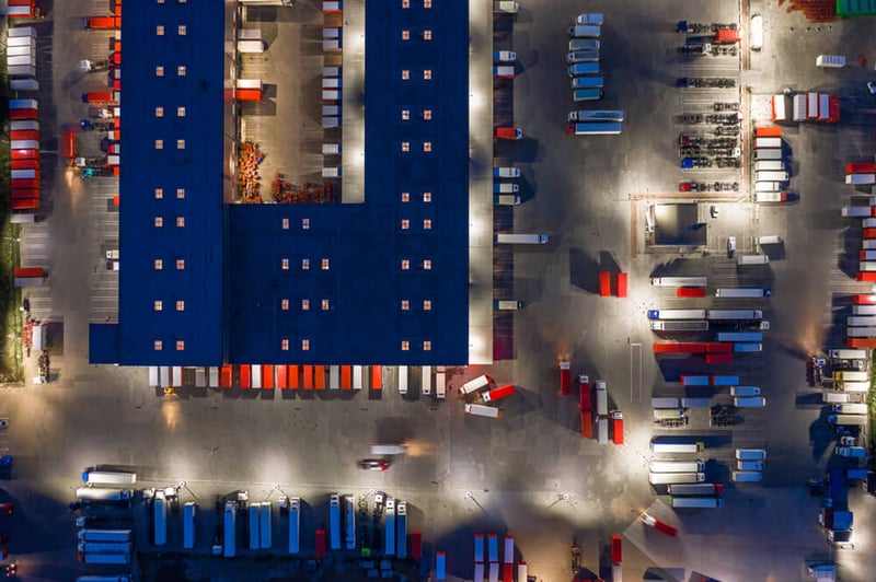 Aerial view of many tractor trailers at a shipping facility