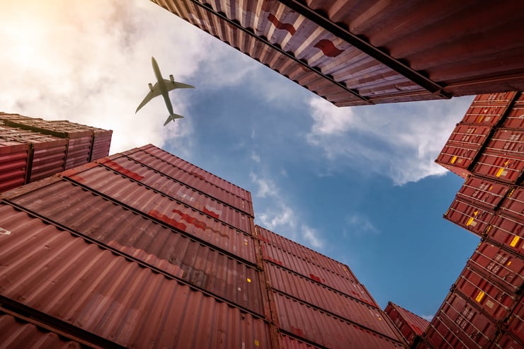 Air Freight plane flying over cargo. 