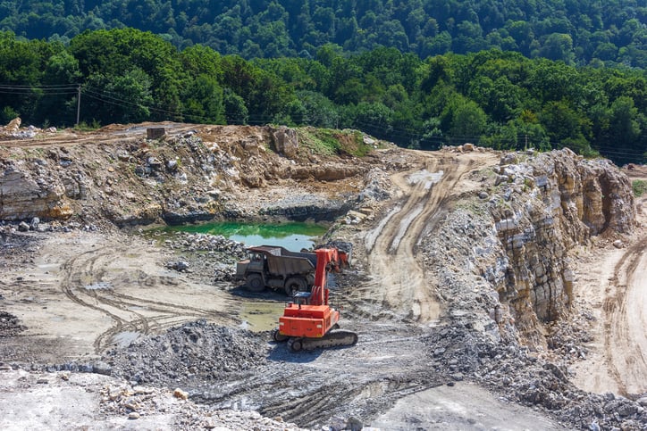 An excavator mining in a gypsum mine. 